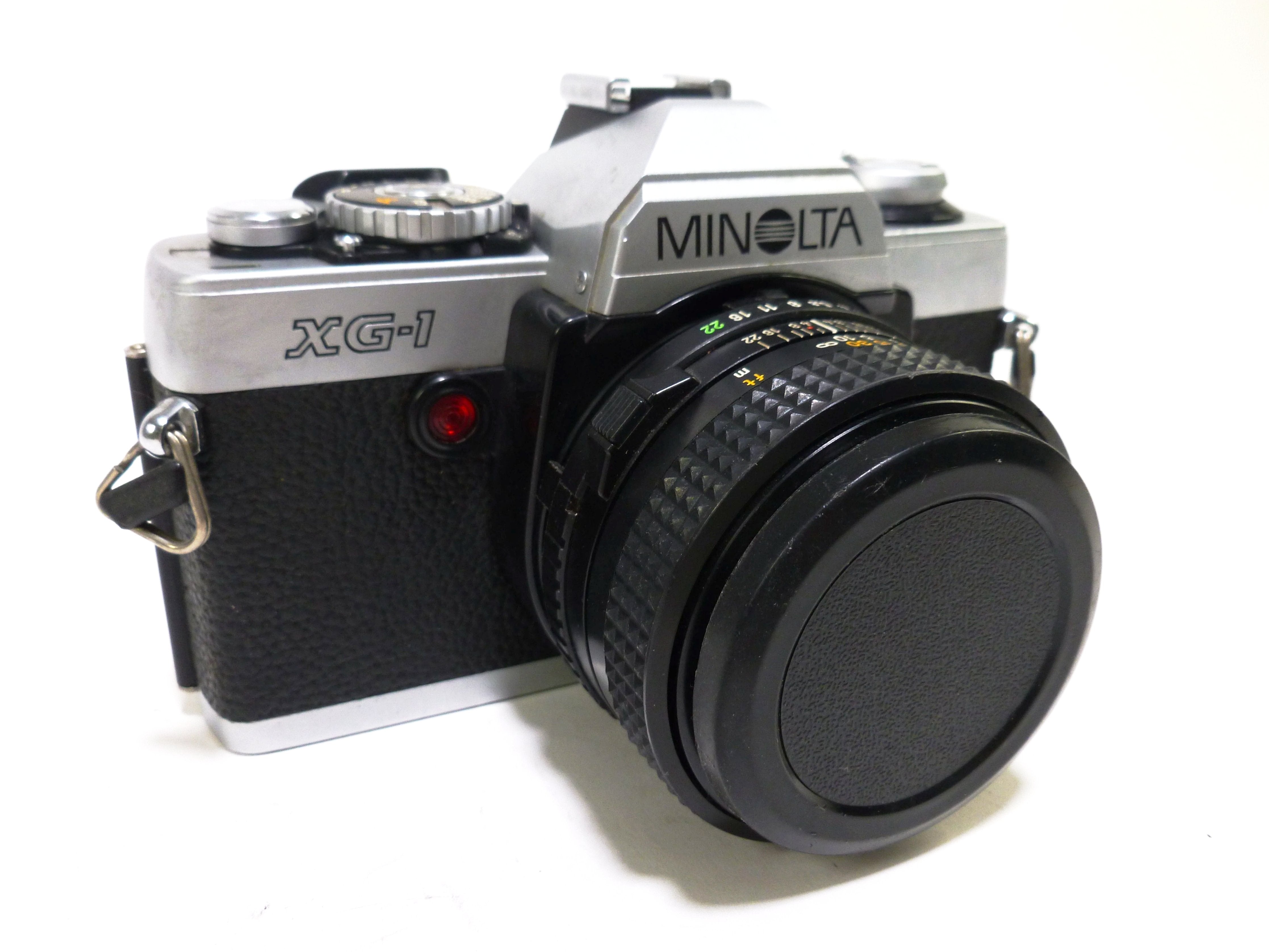 Reflex Argentique SLR Film 35mm MINOLTA XG-1 MF + BOUCHON/SANGLE/PILES Reflex Argentique SLR Film 35mm MINOLTA XG-1 MF + BOUCHON/SANGLE/PILES